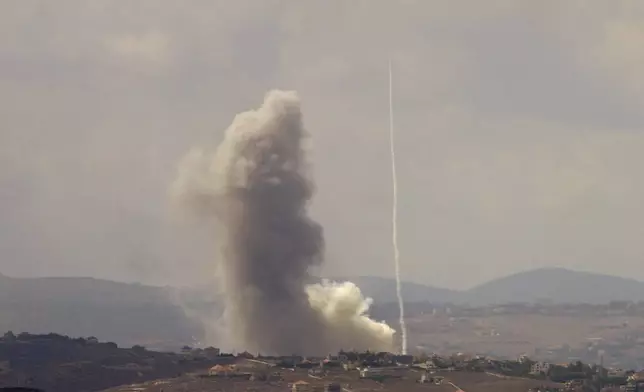 Smoke rises from Israeli airstrikes on Taybeh village, seen from the southern town of Marjayoun, Lebanon, Monday, Sept. 23, 2024. (AP Photo/Hussein Malla)