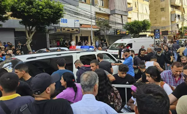 Ambulances arrive at the scene of an Israeli missile strike in the southern suburbs of Beirut, Friday, Sept. 20, 2024. (AP Photo/Hassan Ammar)