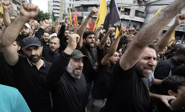 Hezbollah supporters shout slogans during the funeral procession of Hezbollah commander Ibrahim Akil and militant Mahmoud Hamad in Beirut's southern suburb, Sunday, Sept. 22, 2024. (AP Photo/Bilal Hussein)