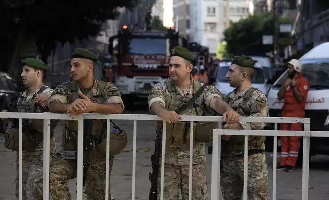 Lebanese soldiers secure the area a day after an Israeli missile strike in Beirut's southern suburbs, Saturday, Sept. 21, 2024. (AP Photo/Bilal Hussein)