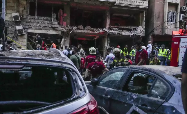 Rescuers work at the scene of an Israeli missile strike in the southern suburbs of Beirut, Friday, Sept. 20, 2024. (AP Photo/Hassan Ammar)