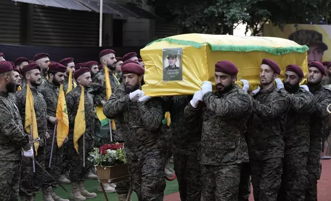 Hezbollah members carry the coffin of Hezbollah commander Ibrahim Akil during the funeral procession in Beirut's southern suburb, Sunday, Sept. 22, 2024. (AP Photo/Bilal Hussein)