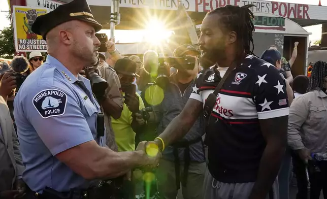 FILE - Minneapolis Police Chief Brian O'Hara, left, shakes hands with Michael Wilson on the three-year anniversary of George Floyd's death at George Floyd Square, Thursday, May 25, 2023, in Minneapolis. (AP Photo/Abbie Parr, File)