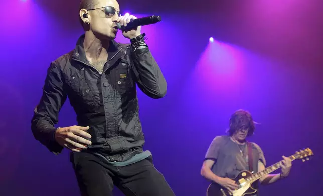 FILE - Chester Bennington, left, performs during the MMRBQ Music Festival 2015 at the Susquehanna Bank Center in Camden, N.J., on May 16, 2015. (Photo by Owen Sweeney/Invision/AP, File)