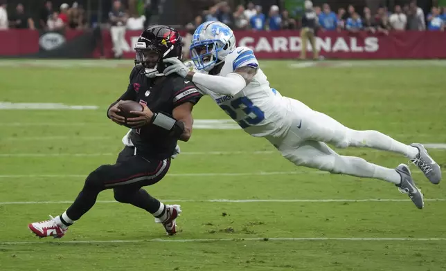 Arizona Cardinals quarterback Kyler Murray (1) rushes for a first down as Detroit Lions cornerback Carlton Davis III (23) defends during the second half of an NFL football game Sunday, Sept. 22, 2024, in Glendale, Ariz. (AP Photo/Rick Scuteri)