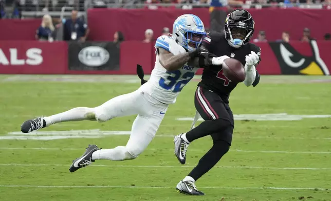 Detroit Lions safety Brian Branch (32) breaks up a pass intended for Arizona Cardinals wide receiver Greg Dortch (4) during the second half of an NFL football game Sunday, Sept. 22, 2024, in Glendale, Ariz. (AP Photo/Rick Scuteri)