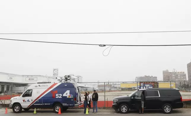 News media prepare to go live in front of a Los Angeles MTA bus depot near the site where overnight a bus was hijacked by an armed subject with passengers on board Wednesday, Sept. 25, 2024, in Los Angeles. One person was fatally shot before police apprehended the suspect. (AP Photo/Ryan Sun)