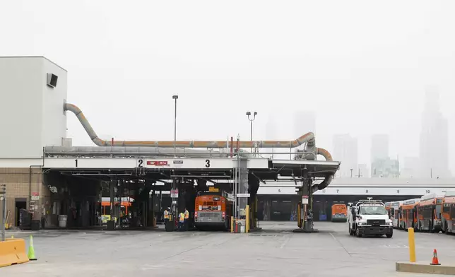 Buses enter a Los Angeles MTA bus depot near the site where overnight a bus was hijacked by an armed subject with passengers on board Wednesday, Sept. 25, 2024, in Los Angeles. One person was fatally shot before police apprehended the suspect. (AP Photo/Ryan Sun)