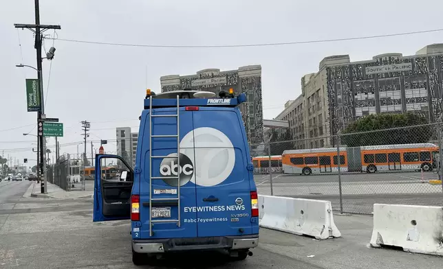 A news truck is parked near the scene of an overnight transit bus hijacking Wednesday, Sept. 25, 2024, in Los Angeles. (AP Photo/Ryan Sun)