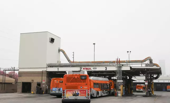 Buses enter a Los Angeles MTA bus depot near the site where overnight a bus was hijacked by an armed subject with passengers on board Wednesday, Sept. 25, 2024, in Los Angeles. One person was fatally shot before police apprehended the suspect. (AP Photo/Ryan Sun)