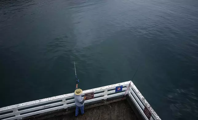 A person fishes on the pier Thursday, Sept. 12, 2024, Malibu, Calif., following a 4.7 magnitude earthquake in the area. (AP Photo/Eric Thayer)