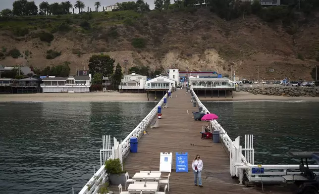 A visitor walks on the pier Thursday, Sept. 12, 2024, in Malibu, Calif., following a 4.7 magnitude earthquake in the area. (AP Photo/Eric Thayer)