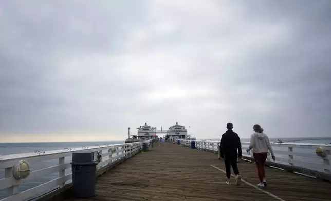 Visitors walk on the pier Thursday, Sept. 12, 2024, in Malibu, Calif., following a 4.7 magnitude earthquake in the area. (AP Photo/Eric Thayer)