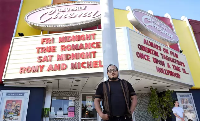 Cinephile Miles Villalon poses near the marquee of the New Beverly Cinema revival theater, Friday, Aug. 9, 2024, in Los Angeles. (AP Photo/Chris Pizzello)