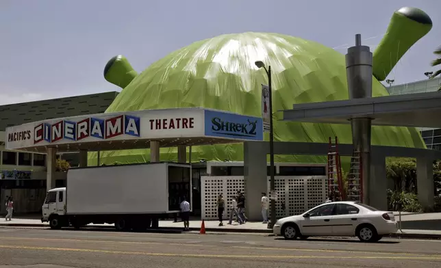 FILE - The dome of the Cinerama theatre is covered by green plastic in the form of animated character Shrek to promote the film "Shrek 2" in Los Angeles on May 19, 2004. (AP Photo/Kevork Djansezian, File)