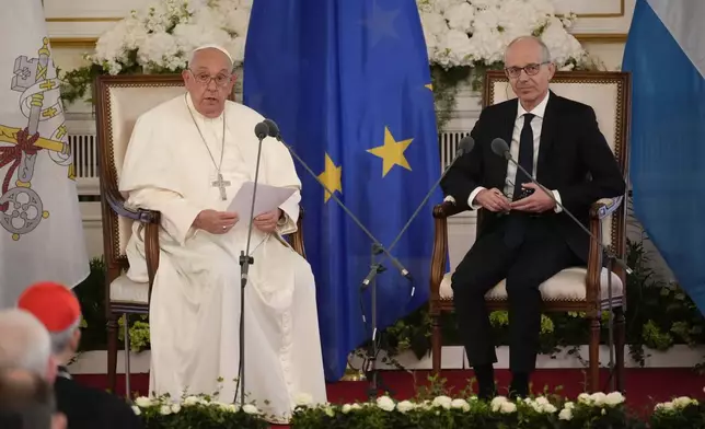 Pope Francis, flanked by Luxembourg's Prime Minister Luc Friede, meets with local authorities, the civil society, and the diplomatic corps in Luxembourg, Thursday, Sept. 26, 2024. (AP Photo/Andrew Medichini)