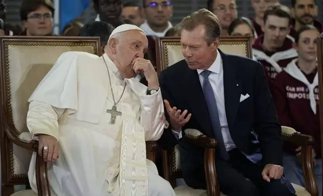 Pope Francis listens to Luxembourg's Grand Duke Henri upon his arrival at Findel International Airport in Luxembourg, Thursday, Sept. 26, 2024. (AP Photo/Andrew Medichini)