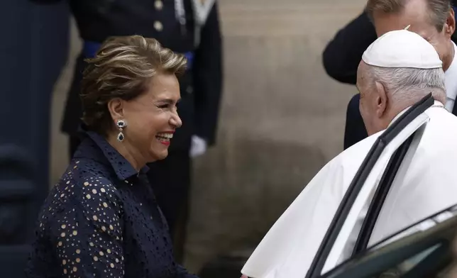 Pope Francis is welcomed by Grand Duchess Maria Teresa, left, and Luxembourg's Grand Duke Henri, right, at the Grand Ducal Palace in Luxembourg, Thursday, Sept. 26, 2024. (AP Photo/Omar Havana)