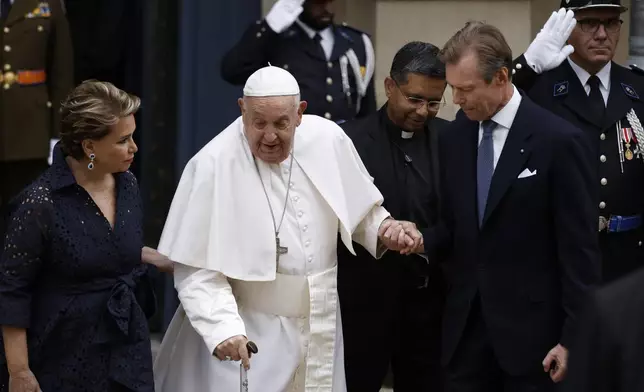 Pope Francis is welcomed by Grand Duchess Maria Teresa, left, and Luxembourg's Grand Duke Henri, right, at the Grand Ducal Palace in Luxembourg, Thursday, Sept. 26, 2024. (AP Photo/Omar Havana)