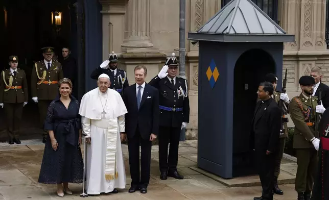 Pope Francis is welcomed by Grand Duchess Maria Teresa, left, and Luxembourg's Grand Duke Henri, right, at the Grand Ducal Palace in Luxembourg, Thursday, Sept. 26, 2024. (AP Photo/Omar Havana)