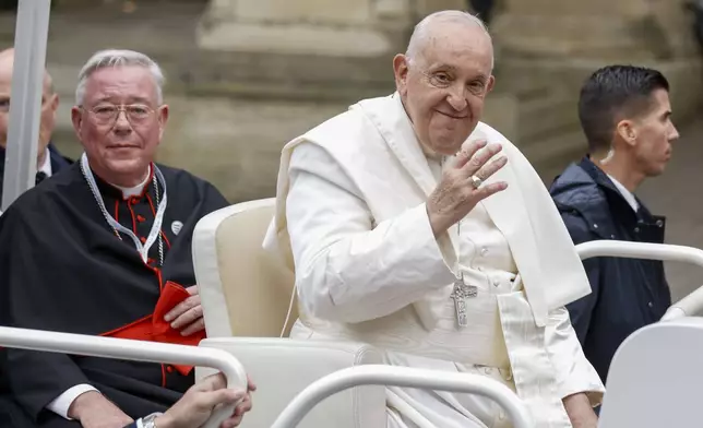 Pope Francis and Archbishop of Luxembourg, Cardinal Jean-Claude Hollerich, left, leave in a popemobile the Cercle-Cite convention center in Luxembourg after a meeting with the national authorities and the civil society on the first day of Francis's four-day visit to Luxembourg and Belgium, Thursday, Sept. 26, 2024. (AP Photo/Omar Havana)