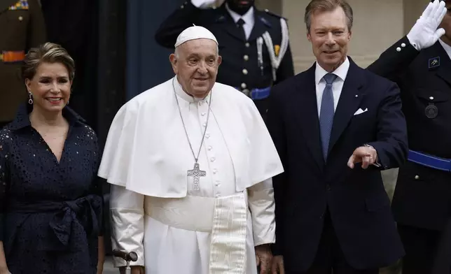 Pope Francis is welcomed by Grand Duchess Maria Teresa, left, and Luxembourg's Grand Duke Henri, right, at the Grand Ducal Palace in Luxembourg, Thursday, Sept. 26, 2024. (AP Photo/Omar Havana)