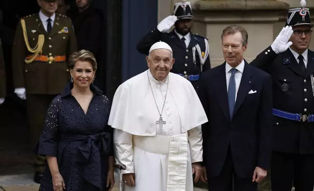 Pope Francis is welcomed by Grand Duchess Maria Teresa, left, and Luxembourg's Grand Duke Henri, right, at the Grand Ducal Palace in Luxembourg, Thursday, Sept. 26, 2024. (AP Photo/Omar Havana)