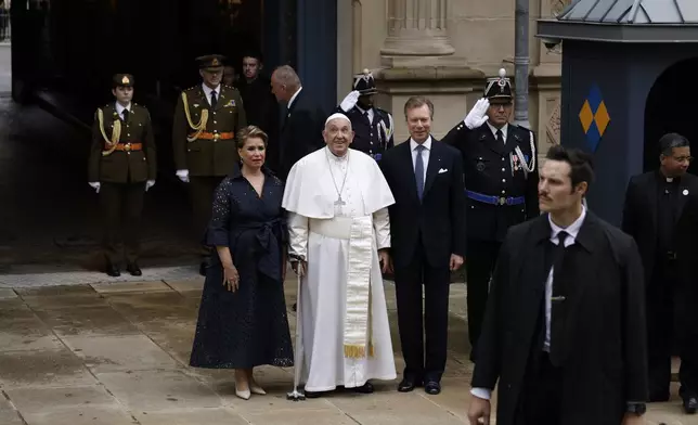 Pope Francis is welcomed by Grand Duchess Maria Teresa, left, and Luxembourg's Grand Duke Henri, right, at the Grand Ducal Palace in Luxembourg, Thursday, Sept. 26, 2024. (AP Photo/Omar Havana)