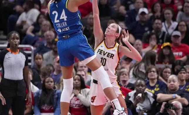 Minnesota Lynx forward Napheesa Collier (24) shoots over Indiana Fever guard Lexie Hull (10) in the second half of a WNBA basketball game in Indianapolis, Friday, Sept. 6, 2024. (AP Photo/Michael Conroy)