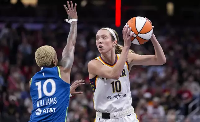 Indiana Fever guard Lexie Hull (10) looks to pass over Minnesota Lynx guard Courtney Williams (10) in the second half of a WNBA basketball game in Indianapolis, Friday, Sept. 6, 2024. (AP Photo/Michael Conroy)