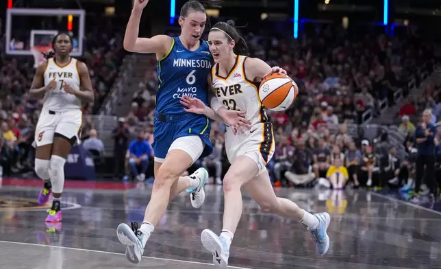 Indiana Fever guard Caitlin Clark (22) drives on Minnesota Lynx forward Bridget Carleton (6) in the second half of a WNBA basketball game in Indianapolis, Friday, Sept. 6, 2024. (AP Photo/Michael Conroy)