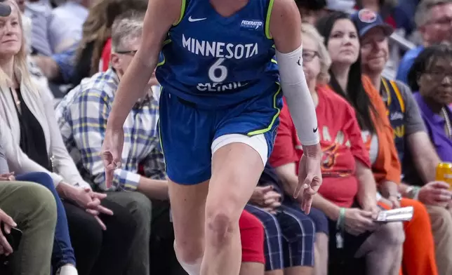 Minnesota Lynx forward Bridget Carleton (6) celebrates after a three-point basket against the Indiana Fever in the second half of a WNBA basketball game in Indianapolis, Friday, Sept. 6, 2024. (AP Photo/Michael Conroy)