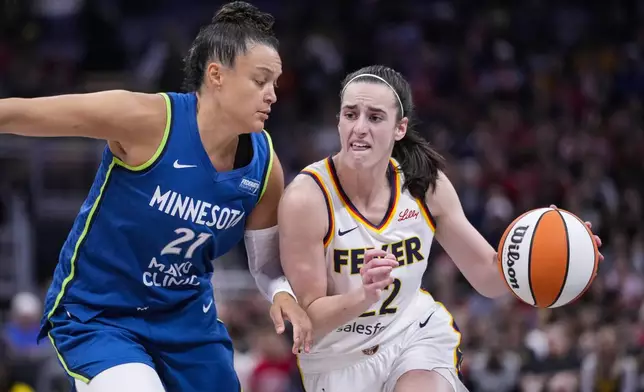 Indiana Fever guard Caitlin Clark (22) drives on Minnesota Lynx guard Kayla McBride (21) in the second half of a WNBA basketball game in Indianapolis, Friday, Sept. 6, 2024. (AP Photo/Michael Conroy)