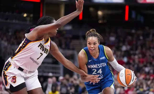 Minnesota Lynx forward Napheesa Collier (24) drives on Indiana Fever forward Aliyah Boston (7) in the first half of a WNBA basketball game in Indianapolis, Friday, Sept. 6, 2024. (AP Photo/Michael Conroy)