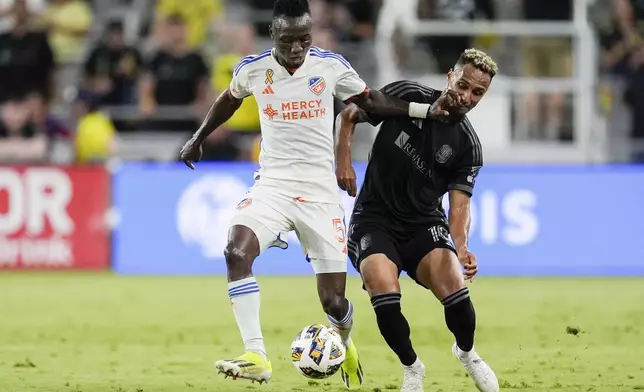 FC Cincinnati midfielder Obinna Nwobodo (5) kicks the ball past Nashville SC midfielder Hany Mukhtar (10) during the second half of an MLS soccer match Saturday, Sept. 21, 2024, in Nashville, Tenn. (AP Photo/George Walker IV)