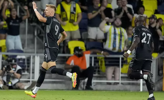 Nashville SC forward Sam Surridge (9) celebrates a goal during the first half of an MLS soccer match against FC Cincinnati, Saturday, Sept. 21, 2024, in Nashville, Tenn. (AP Photo/George Walker IV)