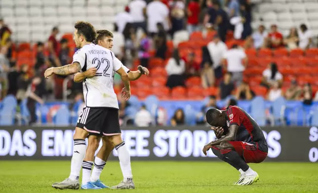 D.C. United defender Aaron Herrera (22) and midfielder Gabriel Pirani, back left, celebrate as Toronto FC forward Prince Osei Owusu, right, reacts after an MLS soccer match in Toronto, Saturday, Aug. 31, 2024. (Christopher Katsarov/The Canadian Press via AP)