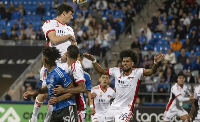 San Jose Earthquakes' Daniel Munie, top left, goes high to head the ball during first-half MLS soccer match action against CF Montreal in Montreal, Saturday, Sept. 28, 2024. (Peter McCabe/The Canadian Press via AP)