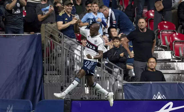 Vancouver Whitecaps' Fafa Picault (11) celebrates after scoring against the San Jose Earthquakes during the first half of an MLS soccer match in Vancouver, British Columbia, Saturday, Sept. 14, 2024. (Ethan Cairns/The Canadian Press via AP)