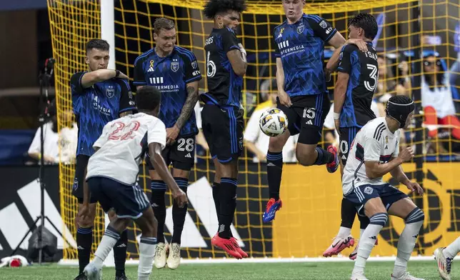 San Jose Earthquakes' Tanner Beason (15) blocks a penalty kick from Vancouver Whitecaps' Ali Ahmed (22) during the first half of an MLS soccer match in Vancouver, British Columbia, Saturday, Sept. 14, 2024. (Ethan Cairns/The Canadian Press via AP)