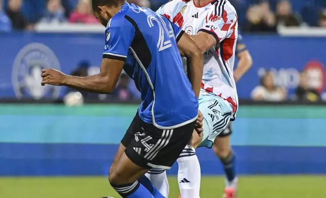 CF Montreal's George Campbell (24) and Chicago Fire's Tom Barlow (12) collide during second-half MLS soccer match action in Montreal, Saturday, Sept. 21, 2024. (Graham Hughes/The Canadian Press via AP)