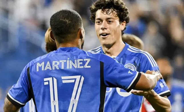 CF Montreal's Josef Martinez (17) celebrates with teammate Caden Clark, right, after scoring against the Chicago Fire during first-half MLS soccer match action in Montreal, Saturday, Sept. 21, 2024. (Graham Hughes/The Canadian Press via AP)