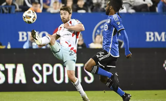 CF Montreal's Raheem Edwards, right, moves in against Chicago Fire's Jonathan Dean, left, during second-half MLS soccer match action in Montreal, Saturday, Sept. 21, 2024. (Graham Hughes/The Canadian Press via AP)