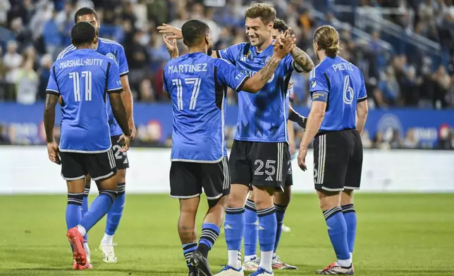 CF Montreal's Josef Martinez (17) celebrates with teammate Gabriele Corbo (25) after scoring against the Chicago Fire during first-half MLS soccer match action in Montreal, Saturday, Sept. 21, 2024. (Graham Hughes/The Canadian Press via AP)