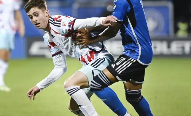 CF Montreal's Jahkeele Marshall-Rutty, right, challenges Chicago Fire's Brian Gutiérrez, left, during second-half MLS soccer match action in Montreal, Saturday, Sept. 21, 2024. (Graham Hughes/The Canadian Press via AP)