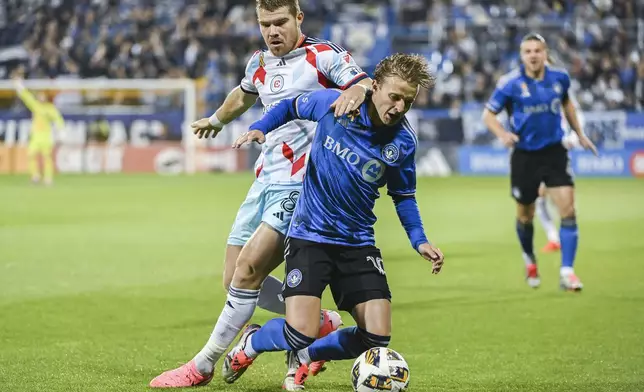 CF Montreal's Bryce Duke, front, is challenged by Chicago Fire's Chris Mueller (8) during first-half MLS soccer match action in Montreal, Saturday, Sept. 21, 2024. (Graham Hughes/The Canadian Press via AP)