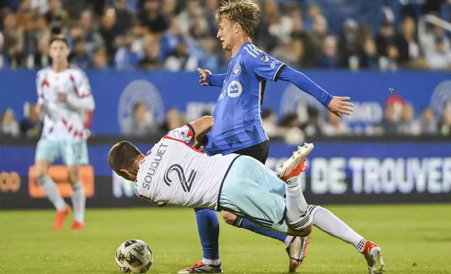 CF Montreal's Bryce Duke, center top, is challenged by Chicago Fire's Arnaud Souquet (2) during first-half MLS soccer match action in Montreal, Saturday, Sept. 21, 2024. (Graham Hughes/The Canadian Press via AP)