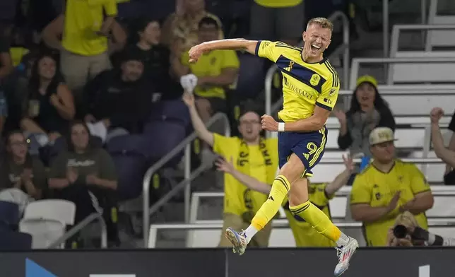 Nashville SC forward Sam Surridge (9) celebrates a goal during the first half of an MLS soccer match against the Chicago Fire, Wednesday, Sept. 18, 2024, in Nashville, Tenn. (AP Photo/George Walker IV)