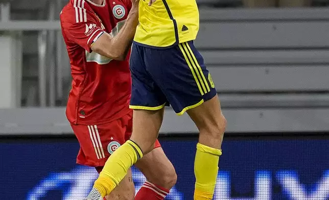 Nashville SC forward Sam Surridge, right, gathers the ball in front of Chicago Fire defender Tobias Salquist, left, during the first half of an MLS soccer match Wednesday, Sept. 18, 2024, in Nashville, Tenn. (AP Photo/George Walker IV)