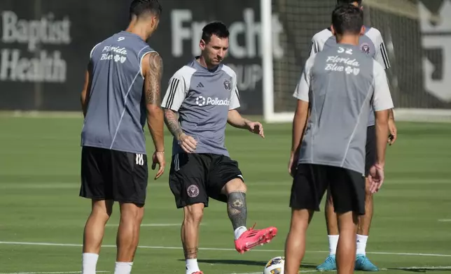 Inter Miami forwards Lionel Messi, center, and Luis Suarez, left, work out with defender Noah Allen, right, at the MLS soccer team's training facility, Friday, Sept. 13, 2024, in Fort Lauderdale, Fla. (AP Photo/Wilfredo Lee)